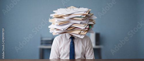 Overworked Businessman Buried Under Pile of Office Paperwork
