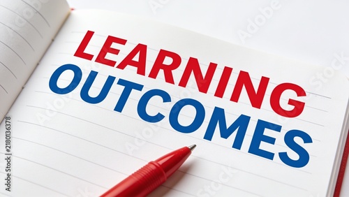Bold red pen writing Learning Outcomes on a white notebook with blue text