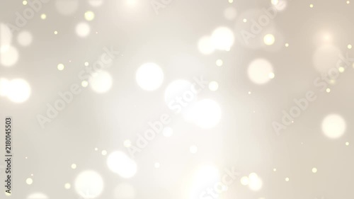 幻想的に輝く光の粒子と玉ボケが浮遊するシャンパンゴールドのシームレスループ動画素材/ Abstract glowing particles and bokeh loop on champagne gold background