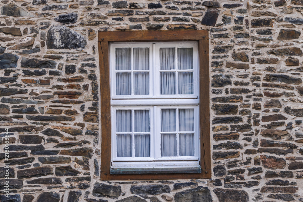 Fototapeta premium White-Paned Window in Rustic Stone Wall