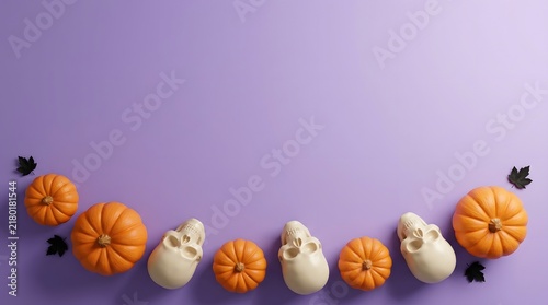 Top view of orange pumpkins and white gourds arranged on a solid purple background with copy space