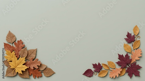 Autumn leaves arranged in corners on a neutral gray background with empty space
