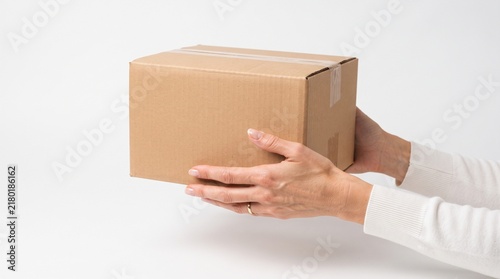 Hands Holding a Sealed Cardboard Shipping Box Ready for Delivery
