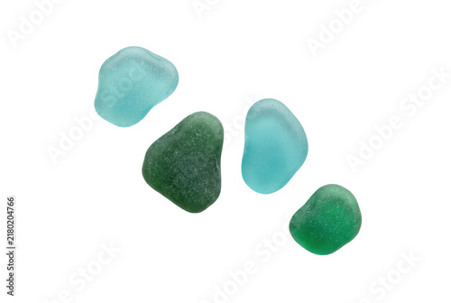 Smooth sea glass pieces in blue and green colors on black background