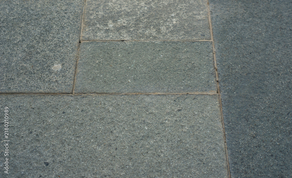 Fototapeta premium Dark stone tiles arranged in a grid pattern