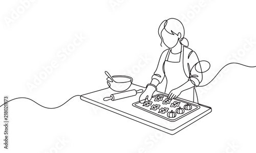 Continuous line of a woman wearing an apron baking pumpkin shaped cookies on a tray in the kitchen with a rolling pin and a mixing bowl on the table on a white background