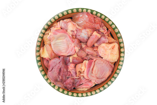 Fotografie Chicken meat offal in a rustic clay plate isolated on a white background