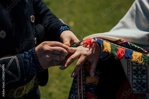 Quadro su tela Close-up of hands during a wedding ring exchange, with one person placing a deco