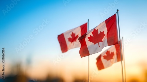 Majestic canadian flags waving proudly against a beautiful blue sky background