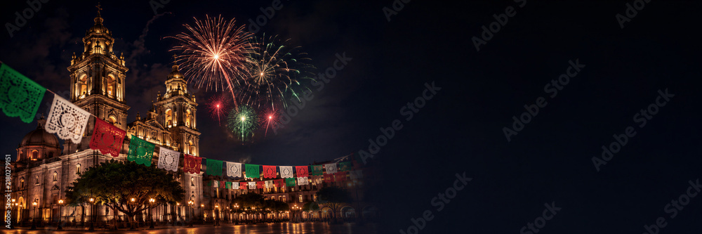 Naklejka premium Night view of illuminated cathedral with fireworks and papel picado garland. Mexican Independence Day celebration with colorful decoration and festive national holiday concept Banner with copy space