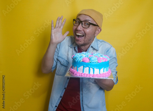 Young Man Holding A Birthday Cake And Showing Excited Expression