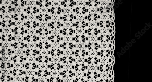 Crochet lace patterns border, crocheted Grandma's Doily, detail of hand-crocheted embroidery, tablecloth, napkin isolated on black background border art design. Craft, vintage linen. Flat lay 