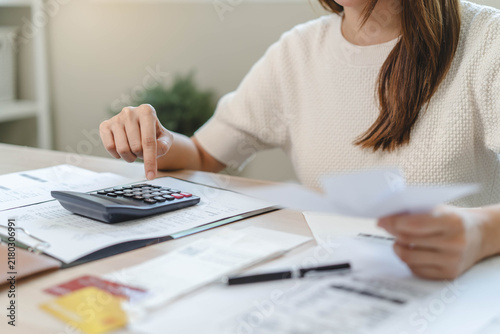 person using calculator calculating tax refund on the table