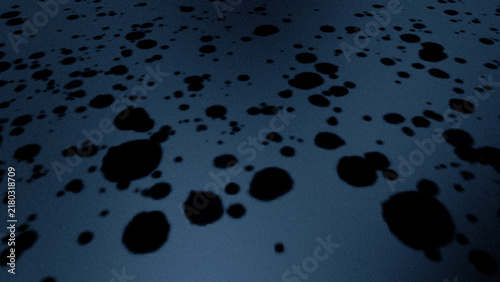 Fotografie Dark droplets scatter across a cool-toned surface