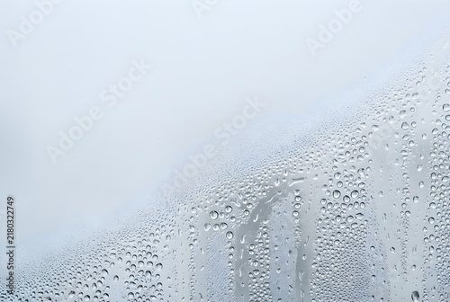 fine condensation mist and tiny water droplets naturally forming on a frosted glass surface, denser moisture patterns with generous negative space for promotional copy
