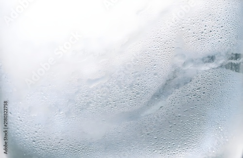 fine condensation mist and tiny water droplets naturally forming on a frosted glass surface, denser moisture patterns with generous negative space for promotional copy
