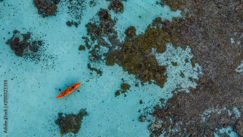 Aerial view of kayak in turquoise lagoon Fakarava French Polynesia