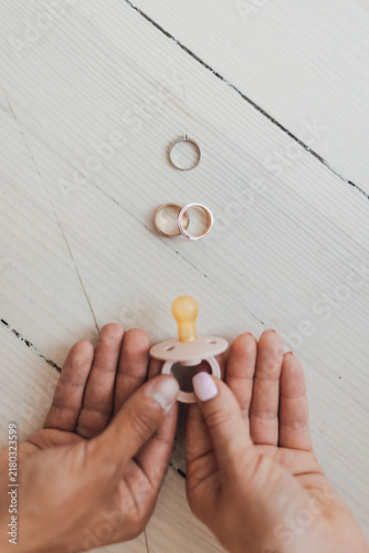 Canvastavla Hands holding baby pacifier near rings intentional parenthood decision
