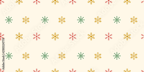 Seamless pattern of colorful snowflakes on a beige background. Minimalist green, yellow, and red stars for Christmas gift wrapping paper, winter textiles, and festive party backdrops.