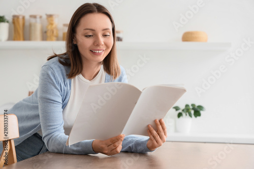 Mindfulness and relaxation, woman reading a magazine at home for leisure and ...