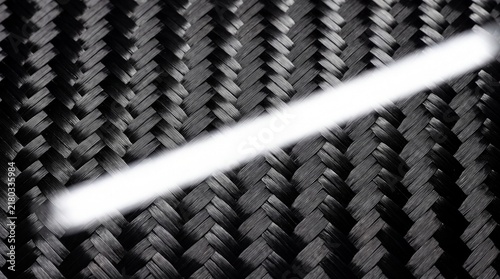 Carbon fiber 2x2 twill weave texture with high gloss clearcoat resin and specular light reflection