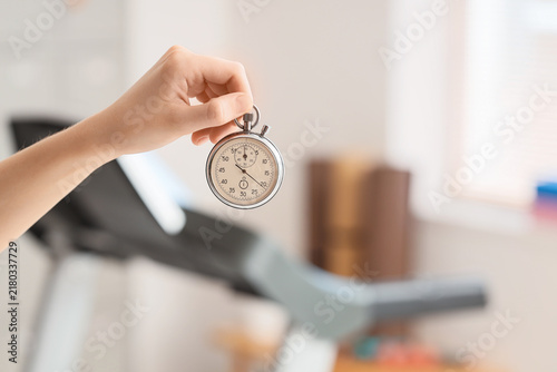 Принти на полотні Time management and fitness training, hand holding a stopwatch for interval work