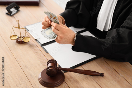 Konstfotografi Judicial corruption and bribery, judge in handcuffs holding cash money with gave