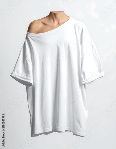 White cotton button down shirt hanging on hanger.