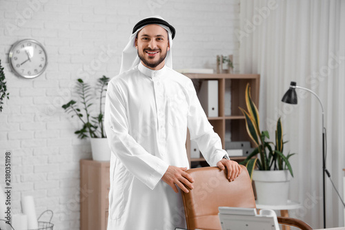 Fotografía Arab businessman near chair in office