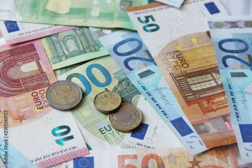 cash money euro and cents banknotes background, representing money, wealth, financial success, savings, investment, and economic prosperity, table full of money.