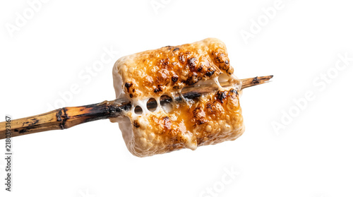 Roasted marshmallow on a wooden stick, toasted golden brown campfire treat, charred sweet snack isolated on white background