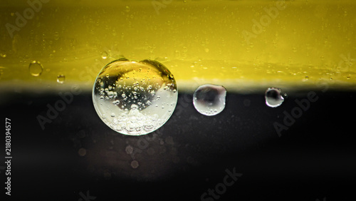 Fotografie Oil and water bubbles separating abstract scientific liquid