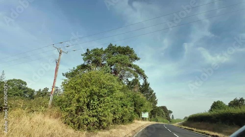 Travelling up a road in England on a hot sunny day.