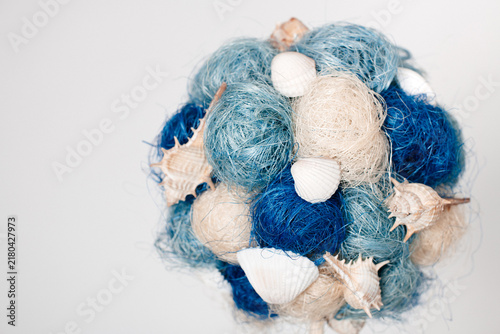 Decorative blue and beige yarn balls with seashells