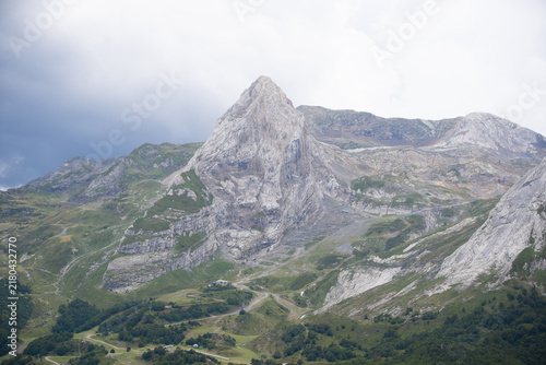 Fotografie Majestic scenery of rough mountain ridge near grassy hills