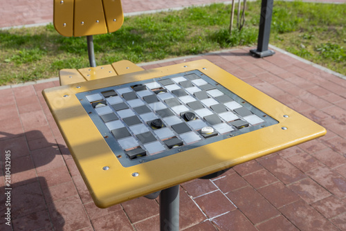 Картината върху платно Outdoor checkers table with built-in board and pieces in public recreation area