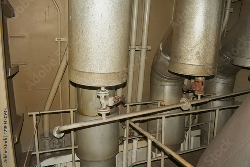 Quadro su tela heavy industrial piping with thermal cladding insulation, shutoff valves, and me