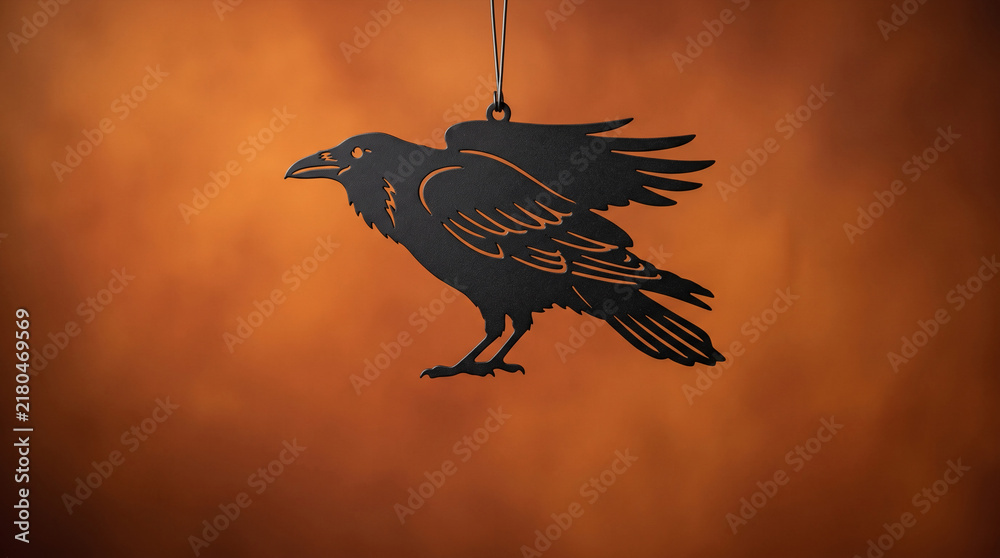 Obraz premium Black raven silhouette ornament hanging against a warm orange gradient background
