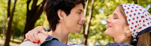 фотографія Couple shares laughter and love during a cozy autumn day in the park, banner