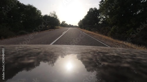 Driving Into Blinding Sunset on Empty Rural Asphalt Road