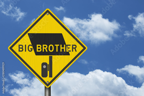 Bild auf Leinwand Surveillance camera icon with big brother text yellow warning sign with sky for