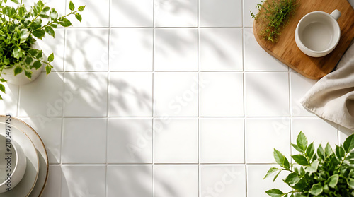 Minimalist white square ceramic tiled wall background featuring soft botanical leaf shadows for elegant interior architecture and home decor