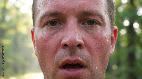 Close up portrait of surprised man face looking directly into camera