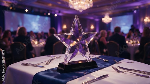 Crystal star award sitting on a formal dining table in a grand ballroom setting with purple ambient lighting and blurred people attending the evening event