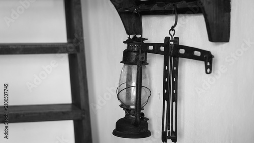 Vintage Lantern and Hand Tools in Rustic Workshop, Black and White