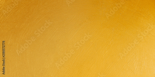 Foto Golden yellow painted wall texture with subtle brushstrokes and distressed surfa