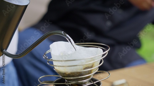 Принти на полотні Making pour-over coffee with a gooseneck kettle outdoors, this slow-brewing method highlights an artisanal approach to a mindful morning ritual while camping in nature