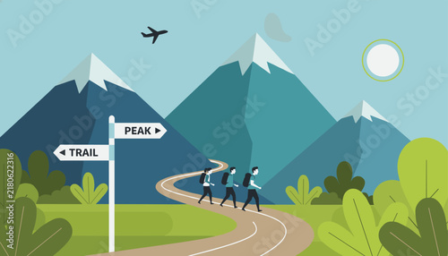 Group of hikers walking along a winding path in the mountains with directional signs for trail and peak under a bright sun.
