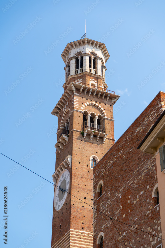 Obraz premium Torre dei Lamberti Medieval Clock Tower View against Blue Sky in Verona Old Town Center Veneto Italy.