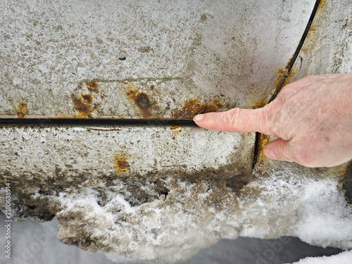 Принти на полотні Close-up view of rust spots and corrosion on car body showing damage and inspect